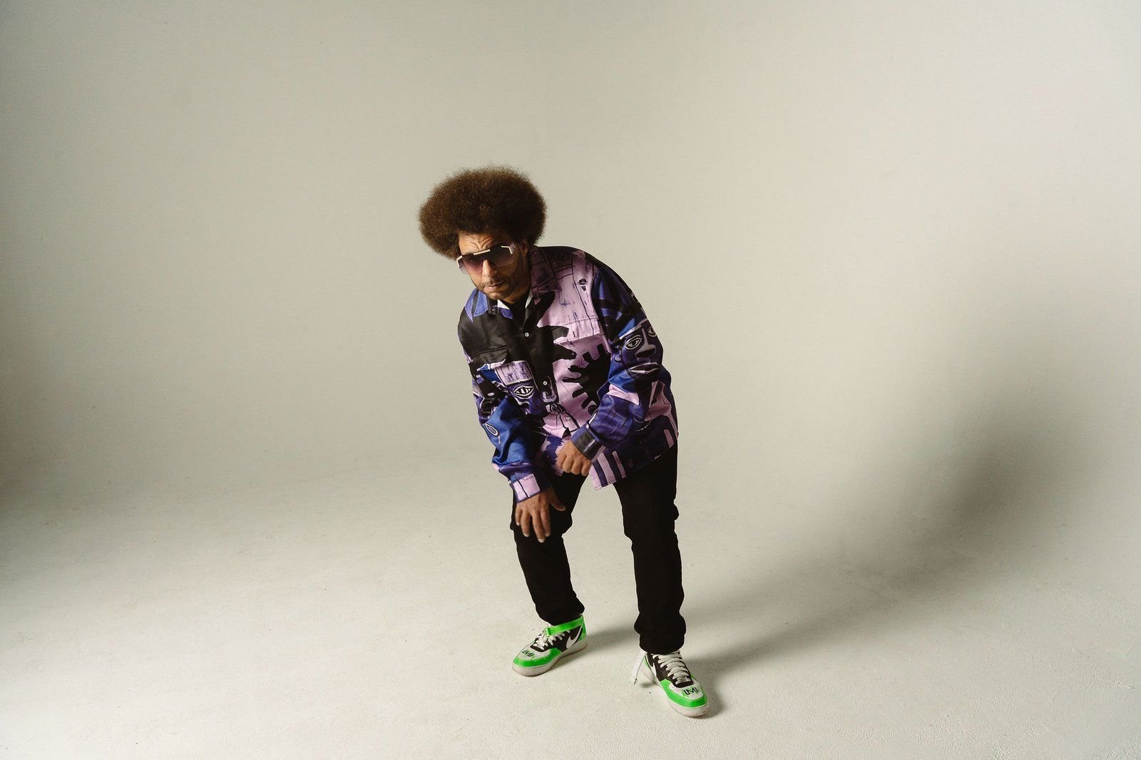 Little Moses Jones posing in a printed jacket and bright sneakers